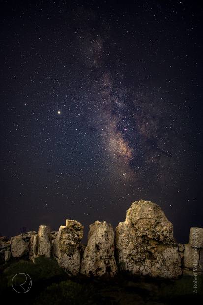 The Milky Way over ancient standing stones at night