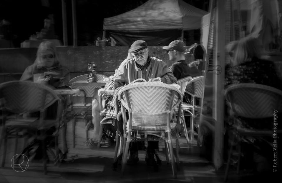 People at the tables of a pavement café, black and white