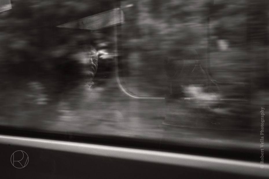 The world going past a vehicle window, blurred into streaks