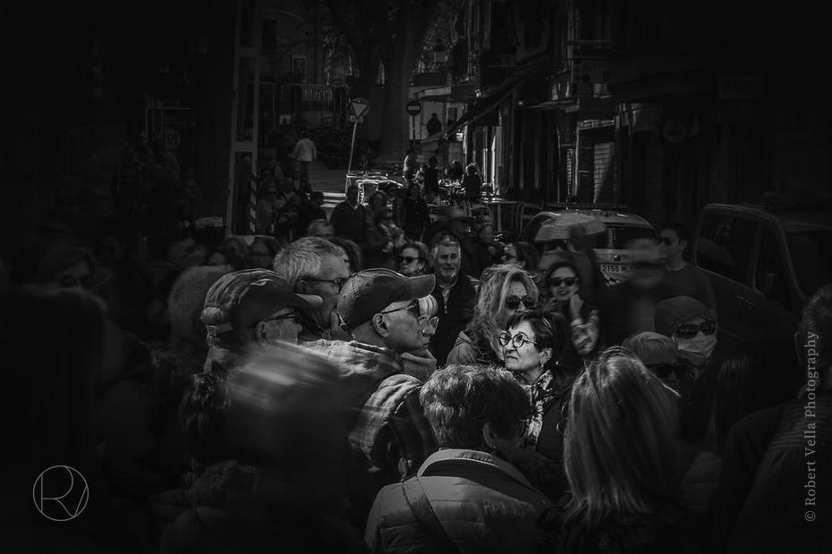 A crowded street at night, black and white