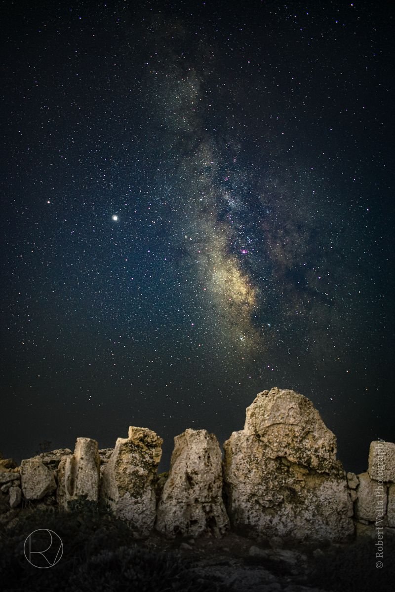 The Milky Way over ancient standing stones at night